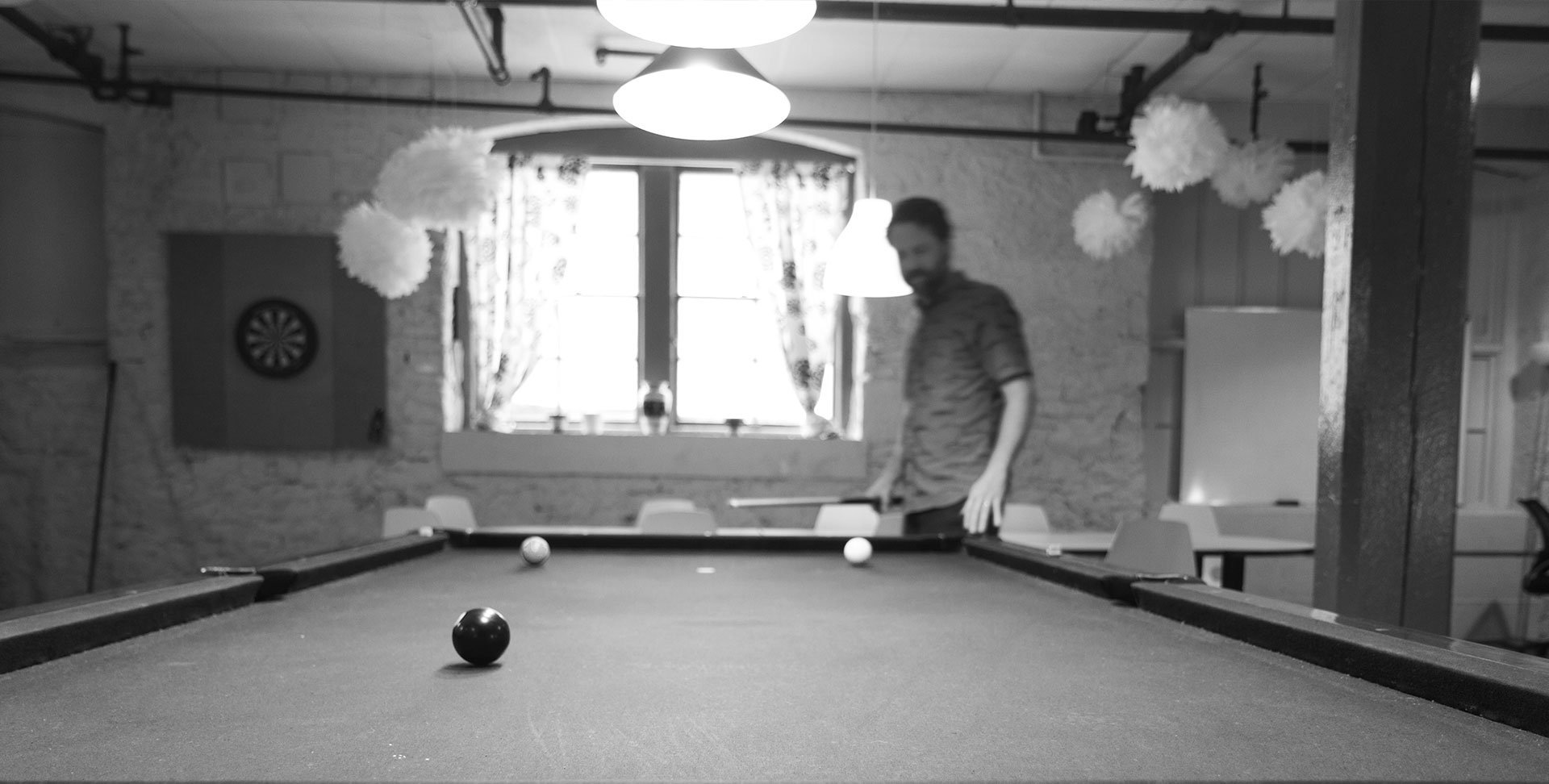 Blue North team member playing billiards